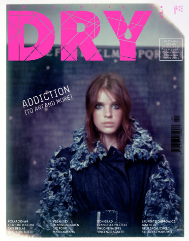 Cover issue 4 Collectible DRY. Marli, actor, model and muse, is wearing a Chanel denim belted trench coat with decorated sleeves and collar; as a backdrop, a masterpiece of Alighiero Boetti, Mettere al mondo il mondo, 1972-73.