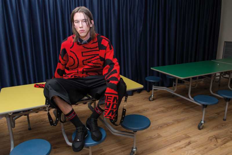 DANCING IN THE EYE OF THE HURRICANE ph. Lorenzo Marcucci for Collectible DRY Armand wears cotton sweater, Stella McCartney, sleeveless shirt and wool pants with straps, Dior Homme, socks, Vetements, sneakers, Versace.