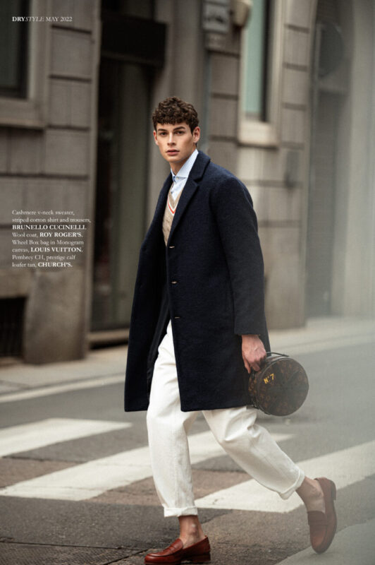 Cashmere v-neck sweater, striped cotton shirt and trousers, BRUNELLO CUCINELLI. Wool coat, ROY ROGER’S. Wheel Box bag in Monogram canvas, LOUIS VUITTON. Pembrey CH, prestige calf loafer tan, CHURCH’S.