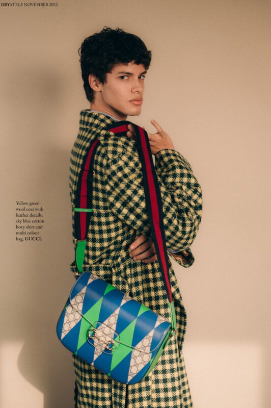 Yellow green wool coat with leather details, sky blue cotton boxy shirt and multi colour bag, GUCCI.