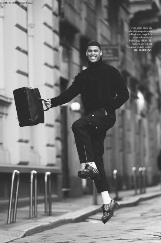 Twin-set in black silk chenille, cargo trousers in black water-repellent technical cover and Birkin bag, HERMES. Platform shoes 1461 animal clash in leather, DR. MARTENS.